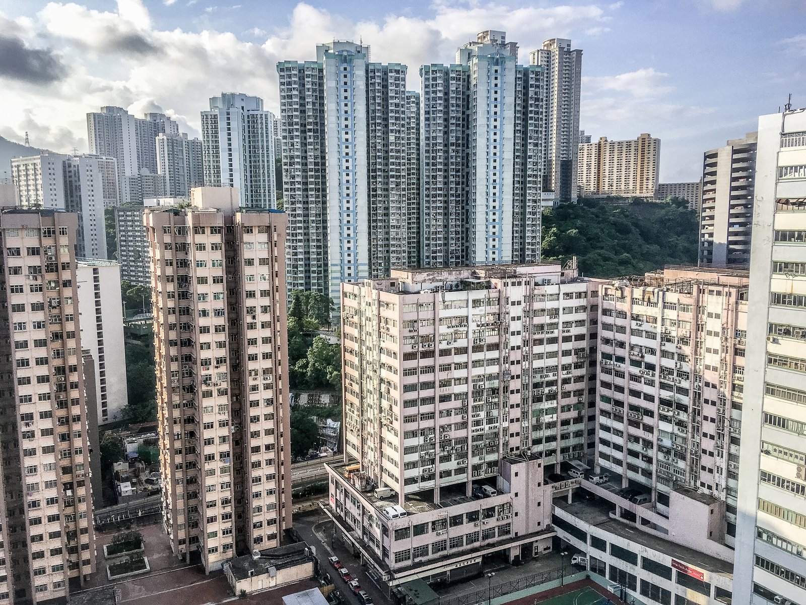 https://expatprimerealty.com/wp-content/uploads/2021/08/wide-angle-shot-several-buildings-hong-kong-built-each-other-daytime-scaled.jpg
